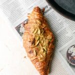 a croissant topped with pistachios