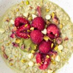 a bowl of green pistachio oats with toppings
