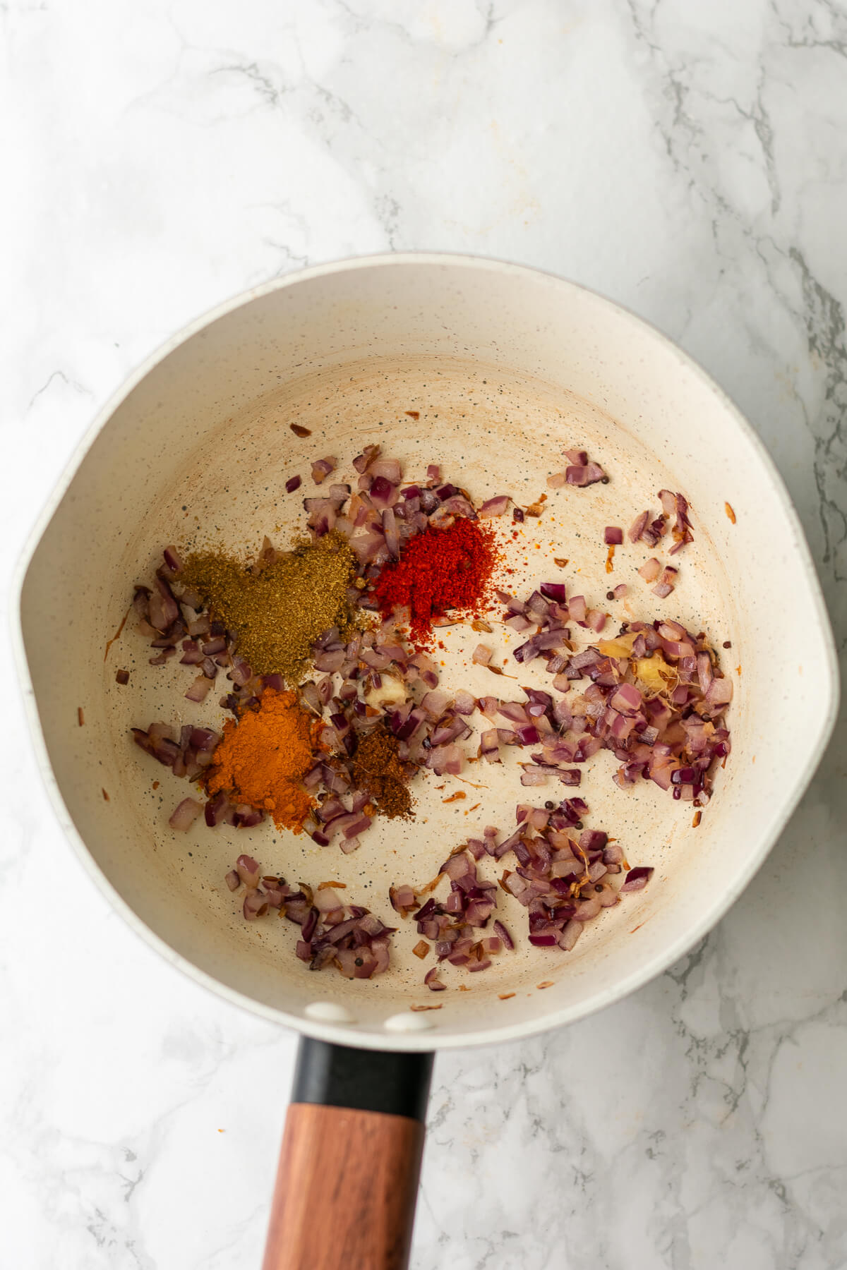 sauted onions in a frying pan with spices