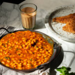 a tray of masala beans served with chai and buttery toast