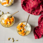 three jars of mango chia pudding with spoons