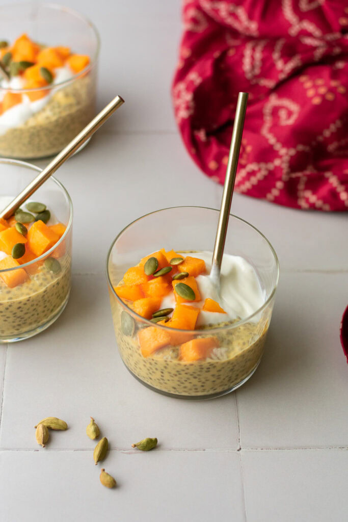 side view of mango chia pudding topped with yogurt and mango chunks