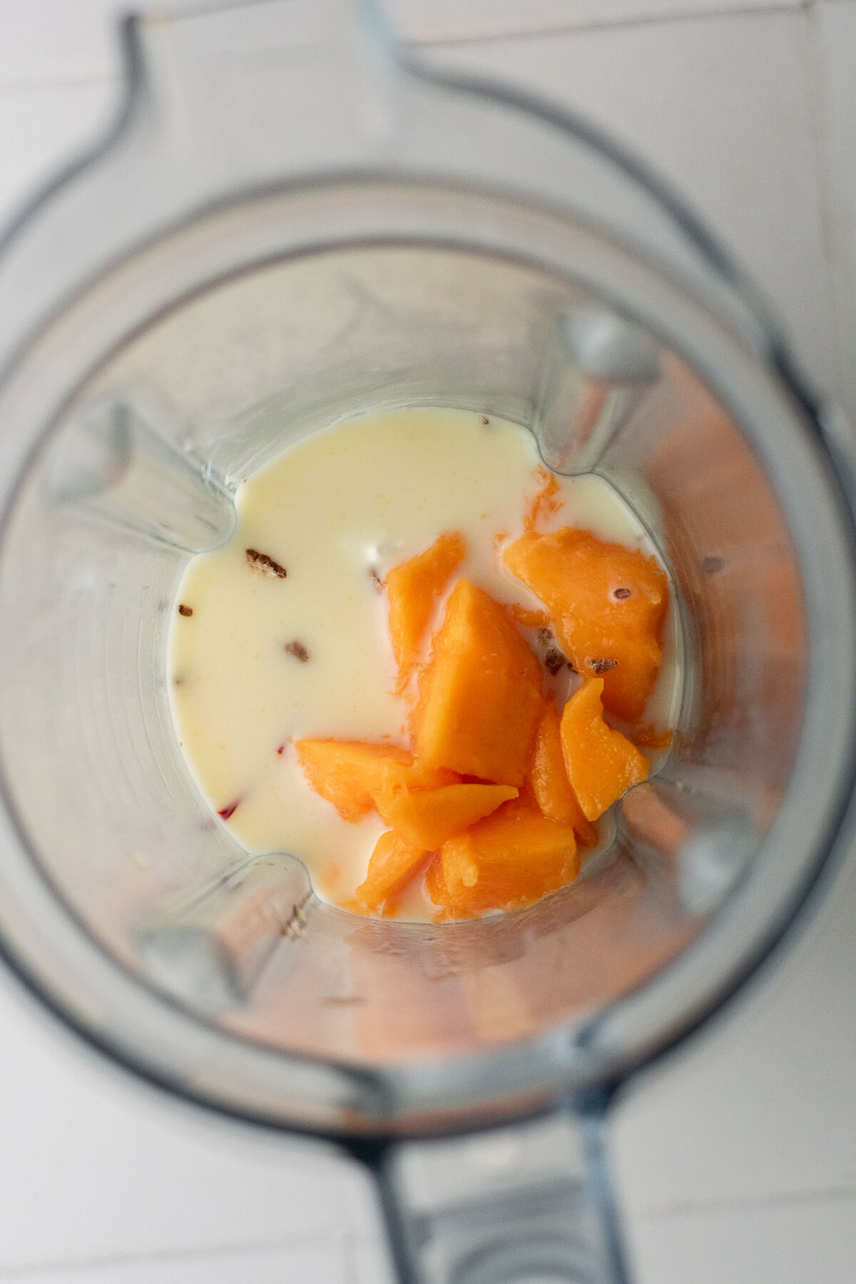 mango, milk, yogurt, cardamom and saffron in a blender jug