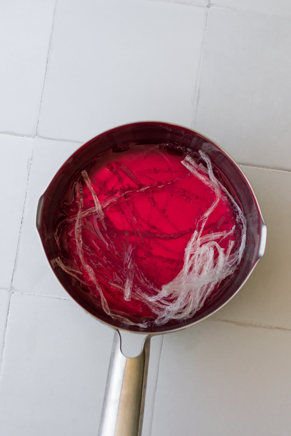 rose syrup, water, sugar and agar agar strips in a saucepan